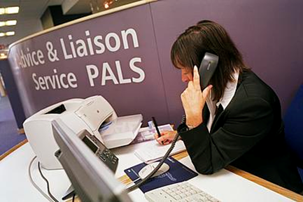 A person taking a phone call for the Patient Advice & Liason Service (PALS)