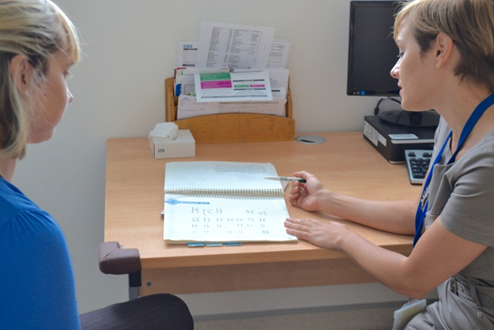 A geneticist discussing a report with a patient