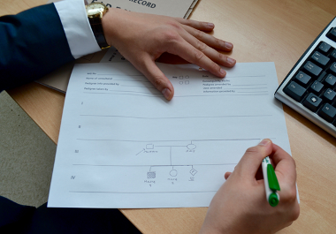 A geneticist drawing a family pedigree diagram